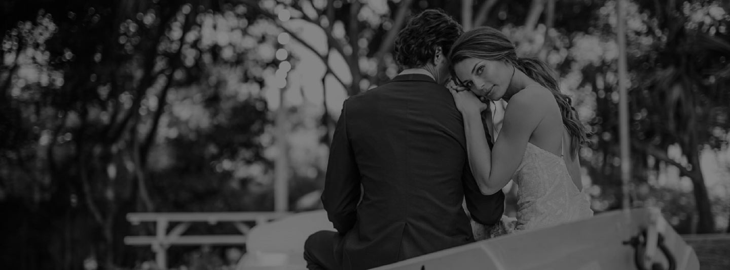 Silhouette of a couple sitting close together outdoors, black and white photo