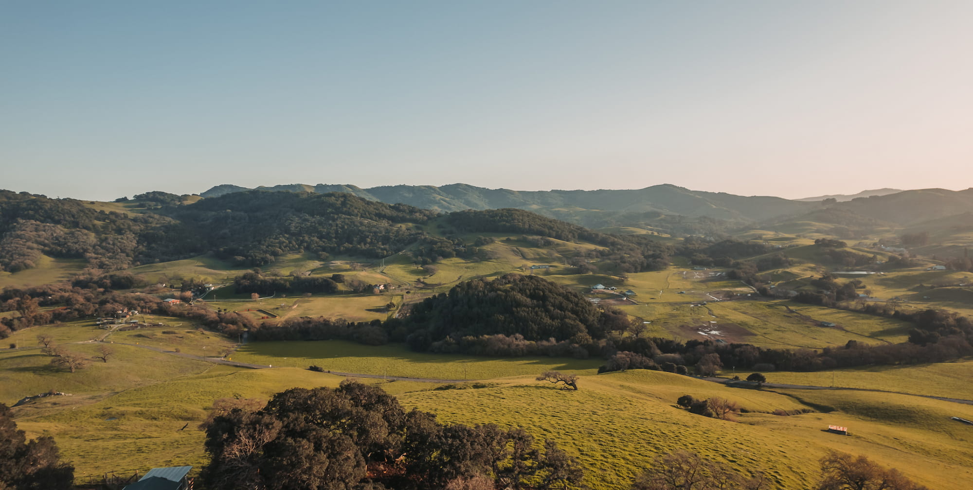 Aerial view of golden rolling hills in Northern California near PIVOT’s retreat