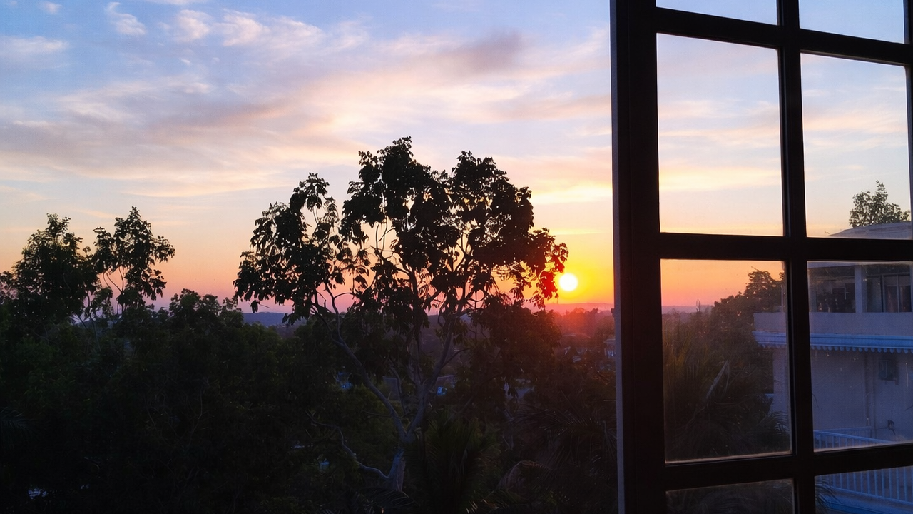Sunrise over the landscape outside a PIVOT retreat home window
